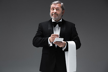 Image showing Waiter taking an order wearing a waistcoat in a fancy restaurant