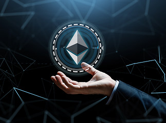 Image showing businessman hand with ethereum over binary code