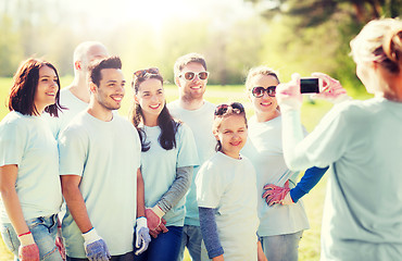 Image showing group of volunteers taking picture by smartphone