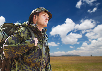 Image showing soldier in military uniform with backpack hiking
