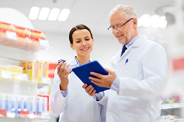 Image showing apothecaries with tablet pc and drug at pharmacy