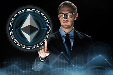 Image showing businessman hand with ethereum hologram over black