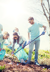 Image showing volunteers with garbage bags cleaning park area