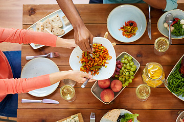 Image showing people eating salad at table with food