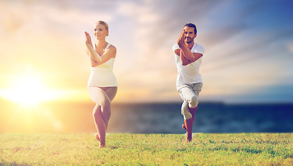 Image showing couple making yoga eagle pose outdoors