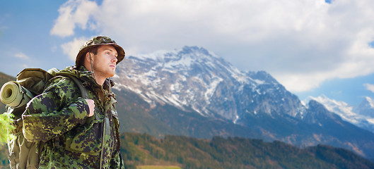 Image showing soldier in military uniform with backpack hiking