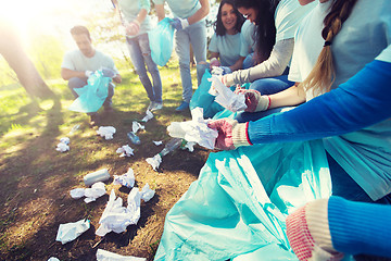 Image showing volunteers with garbage bags cleaning park area