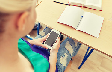 Image showing student girl with smartphone texting at school