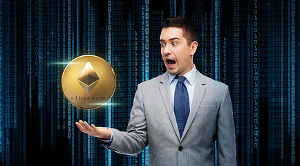 Image showing excited businessman with etherum over binary code