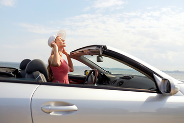 Image showing happy young woman in convertible car