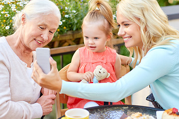 Image showing happy family taking selfie at cafe