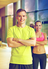 Image showing smiling man and woman in gym