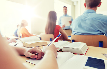 Image showing student with smartphone and notebook at school