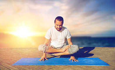 Image showing man doing yoga scale pose outdoors