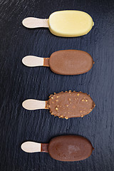 Image showing Ice cream on stick covered with chocolate 