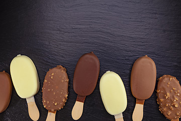 Image showing Ice cream on stick covered with chocolate 