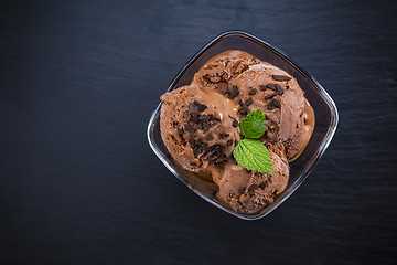 Image showing Scoops chocolate ice cream in glass bowl