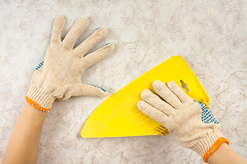 Image showing hands smoothing wallpaper with spatula