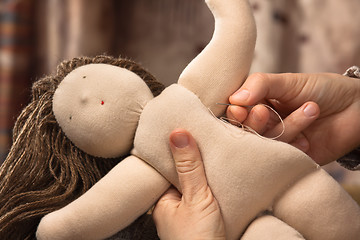 Image showing hand sewing a Waldorf doll