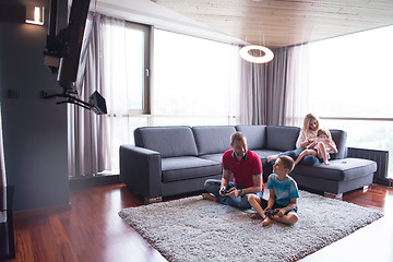 Image showing Happy family playing a video game