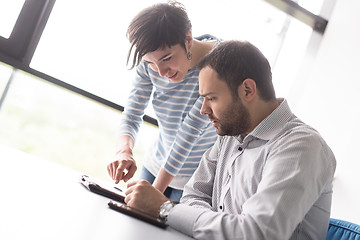 Image showing Two Business People Working With Tablet in startup office