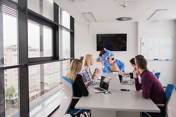 Image showing boss dresed as bear having fun with business people in trendy of