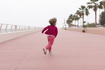 Image showing cute little girl on the promenade by the sea