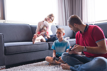 Image showing Happy family playing a video game