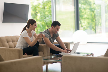 Image showing happy young couple buying online