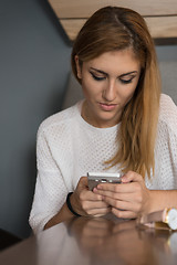 Image showing young woman using mobile phone