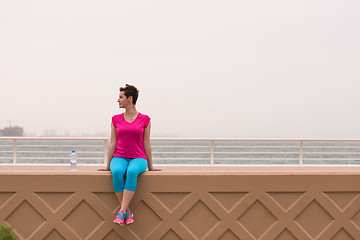 Image showing young woman sitting after a successful training run