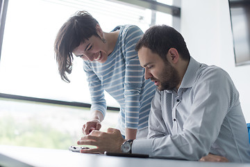 Image showing Two Business People Working With Tablet in startup office