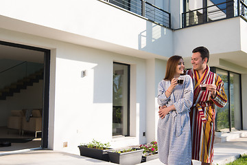 Image showing Young beautiful couple in bathrobes