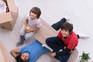 Image showing boys with cardboard boxes around them top view