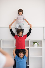 Image showing young boys posing line up piggyback