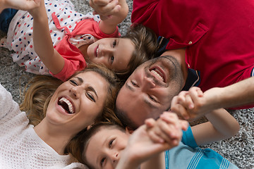 Image showing happy family lying on the floor