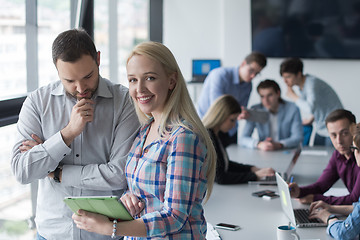 Image showing Two Business People Working With Tablet in office