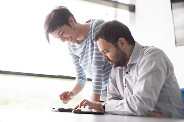 Image showing Two Business People Working With Tablet in startup office