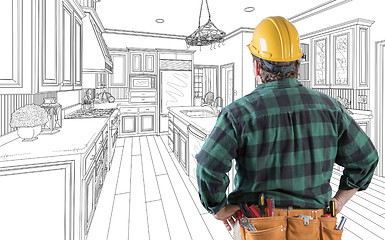 Image showing Male Contractor with Hard Hat and Tool Belt Looking At Custom Ki