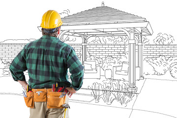 Image showing Contractor Standing Looking At Patio Pergola Design Drawing.