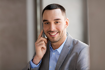 Image showing businessman calling on smartphone at office