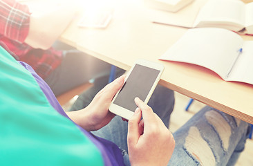 Image showing student girl with smartphone texting at school