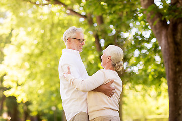 Image showing happy senior couple dancing at summer park