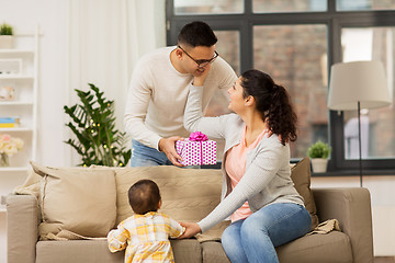 Image showing happy family with birthday present at home