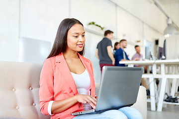 Image showing happy woman with laptop working at office