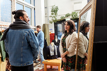 Image showing couple choosing clothes at vintage clothing store