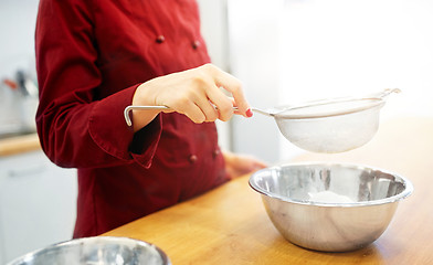 Image showing chef with flour in bowl making batter or dough