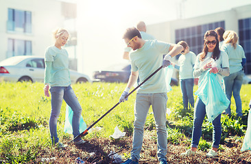 Image showing volunteers with garbage bags cleaning park area