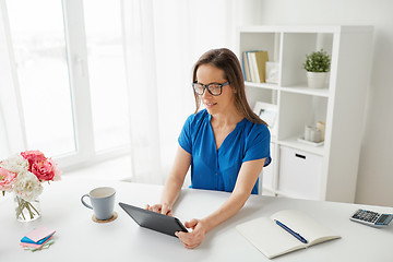 Image showing woman with tablet pc and coffee at home or office