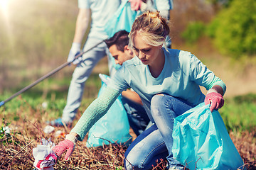 Image showing volunteers with garbage bags cleaning park area